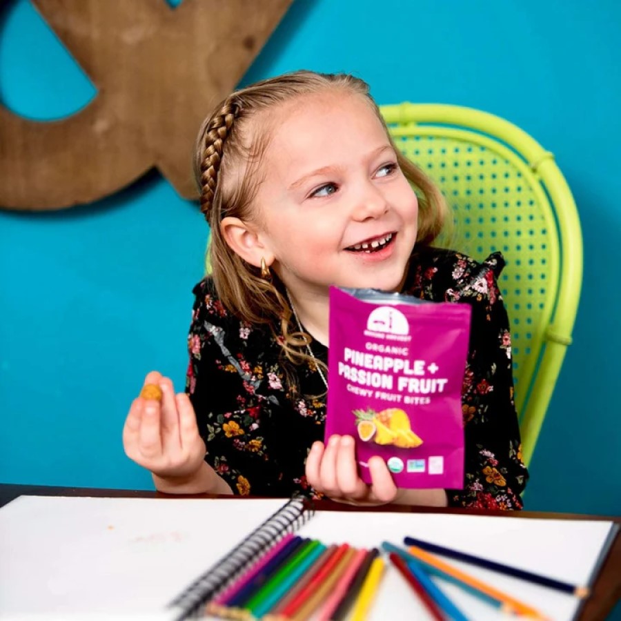Young Girl Eating Healthy After School Snack Food Organic Mavuno Harvest Pineapple Passionfruit Bites