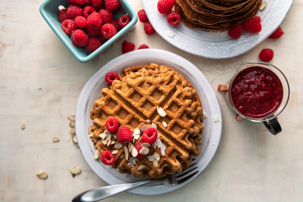 Healthy Gluten And Grain Free Waffles And Pancakes With Sliced Almonds And Fresh Raspberries Made With Bobs Red Mill GF Cassava Flour