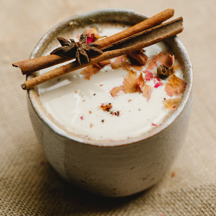 Organic Masala Chai tea garnish with flowers and cinnamon sticks with perfect latte foam