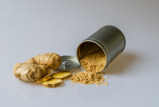 Fresh Ginger Root With Slices And Ginger Powder In Silver Container