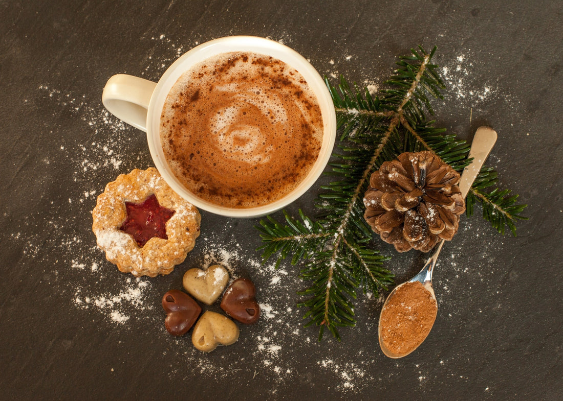Mug Of Golden Cocoa Coffee With Spoonful Of Cocoa Powder Posed With Cookie And Pine Cone