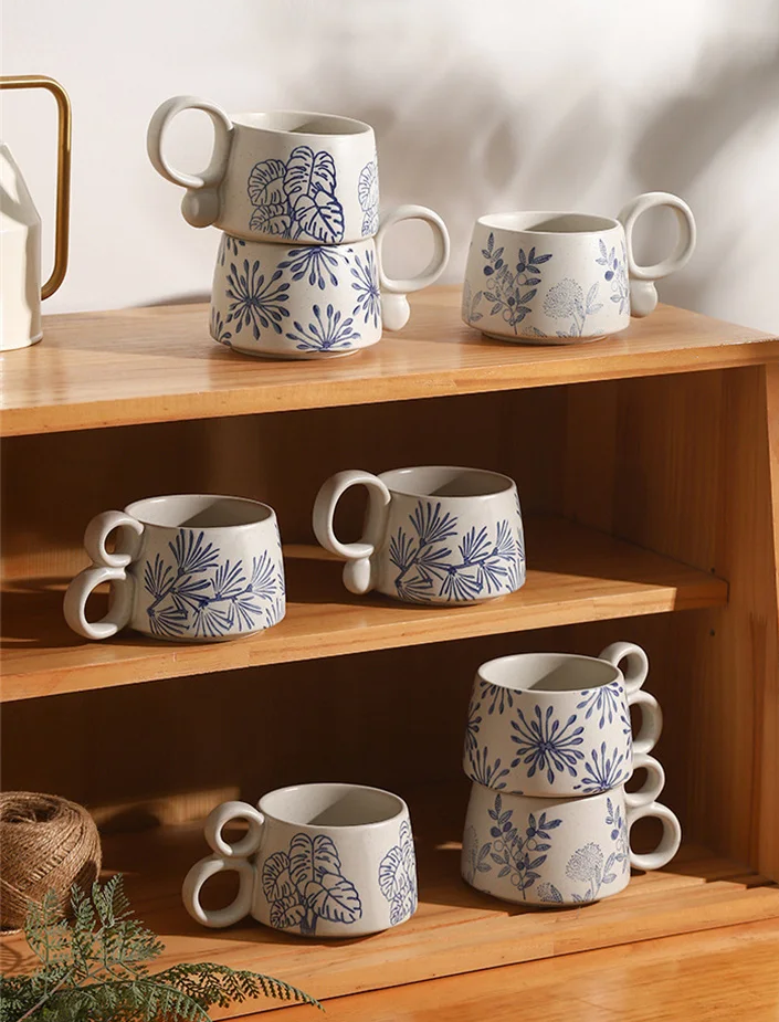 Stacked Mugs On Open Wooden Shelves Kitchen Coffee Bar Decor Nature In Blue Ceramic Cups With Loop Handles And Garden Inspired Plant Patterns