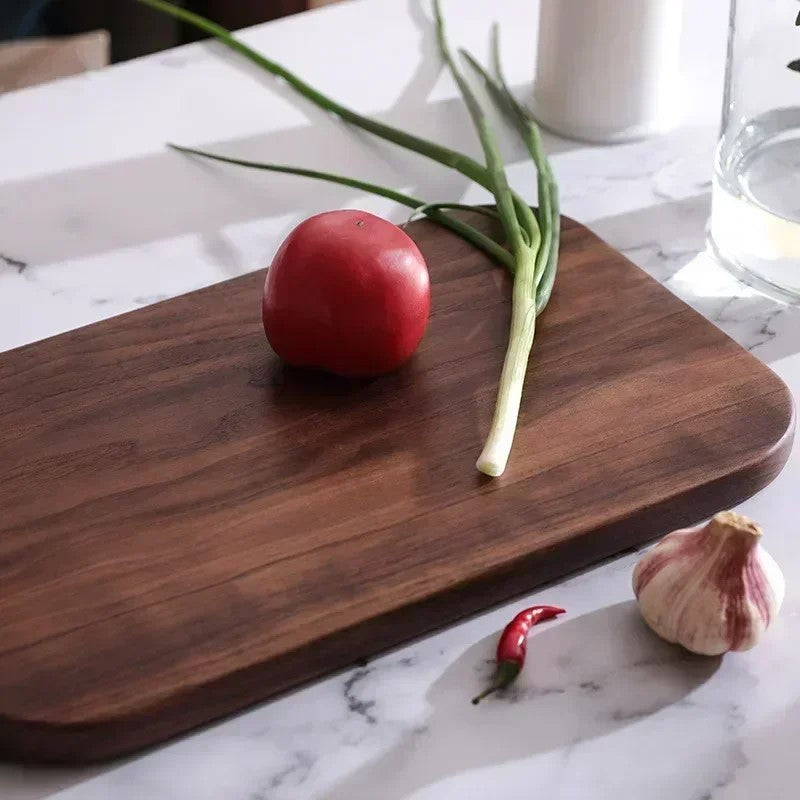Black Walnut Cutting Board On Kitchen Countertop With Fresh Clean Food Ingredients