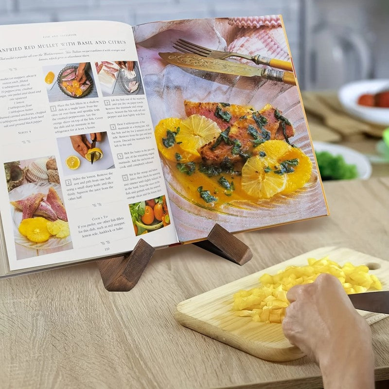 Home Chef Cooking And Preparing Ingredients While Reading Cookbook On Wood Stand With Cross Design