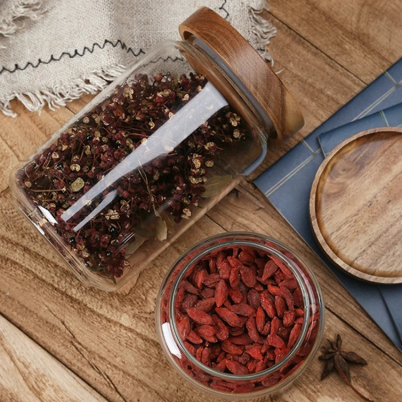 Organic Goji Berries And Herbs In Glass Storage Jars With Sealable Lids