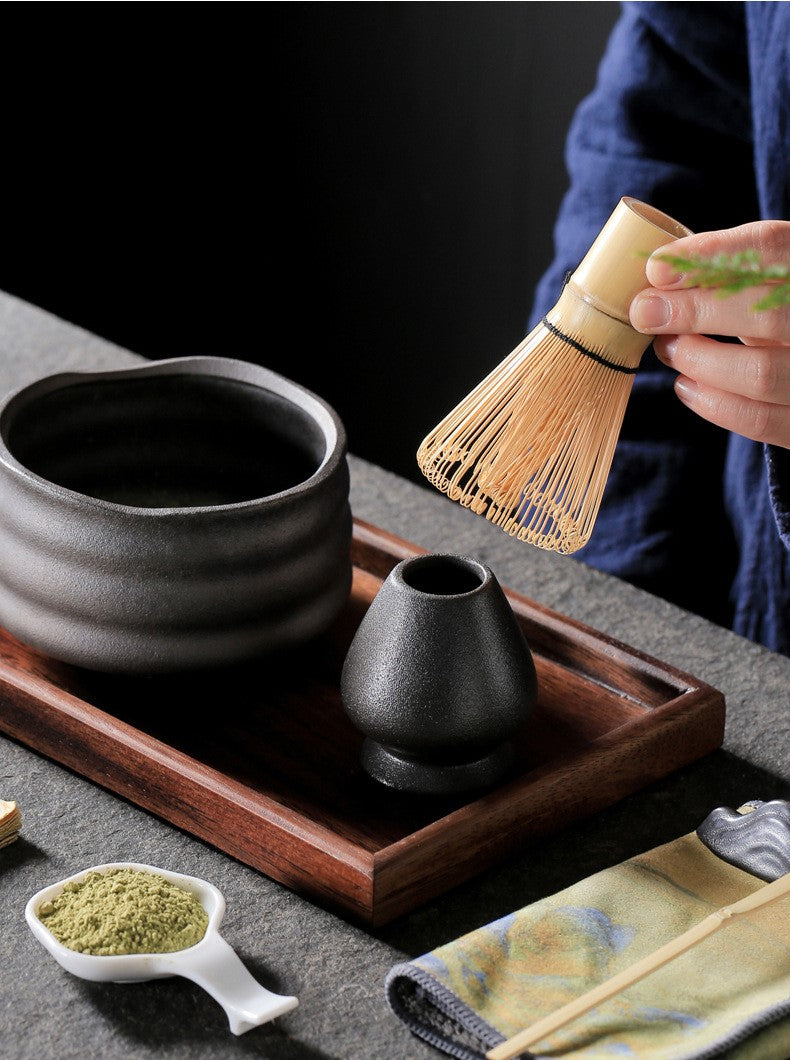 Holding Bamboo Matcha Whisk For Making Ceremonial Tea