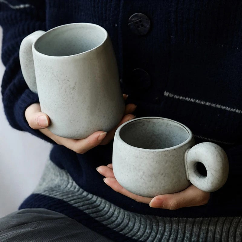 Holding Ceramic Mugs With Oversized Handles Shallow And Deep Cups In Organic Retro Style