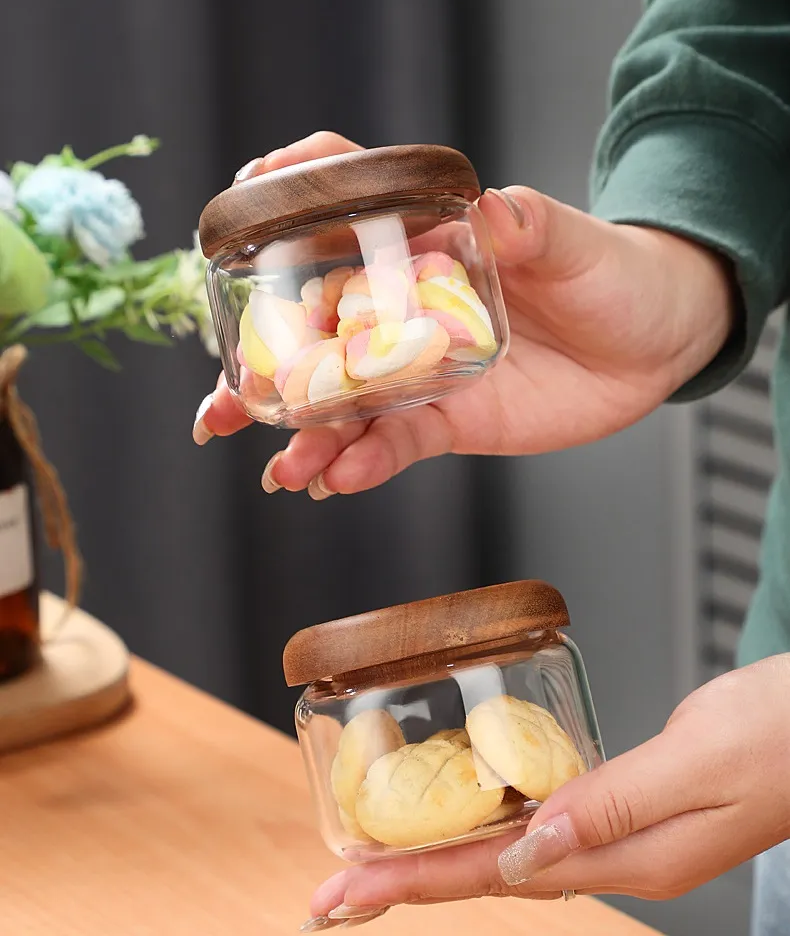 Holding Small Glass Jars With Wood Lids Food Storage Canisters From The Wilder Collection Perfect For Snacks Candy And More