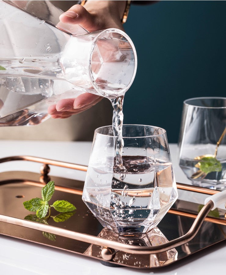 Pouring Water Out Of Stylish Glass Pitcher Nordic Fractal Carafe And Matching Cups