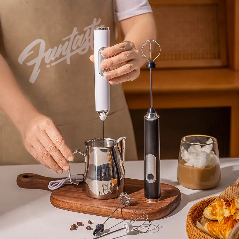 Making Cafe Style Coffee Drinks With Modern Barista Tools USB Rechargeable Handheld Milk Frother Wands In White And Black With Stainless Steel Attachments