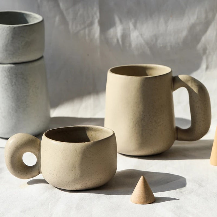 Retro Style Pottery Mugs With Organic Shapes And Oversized Chunky Handles