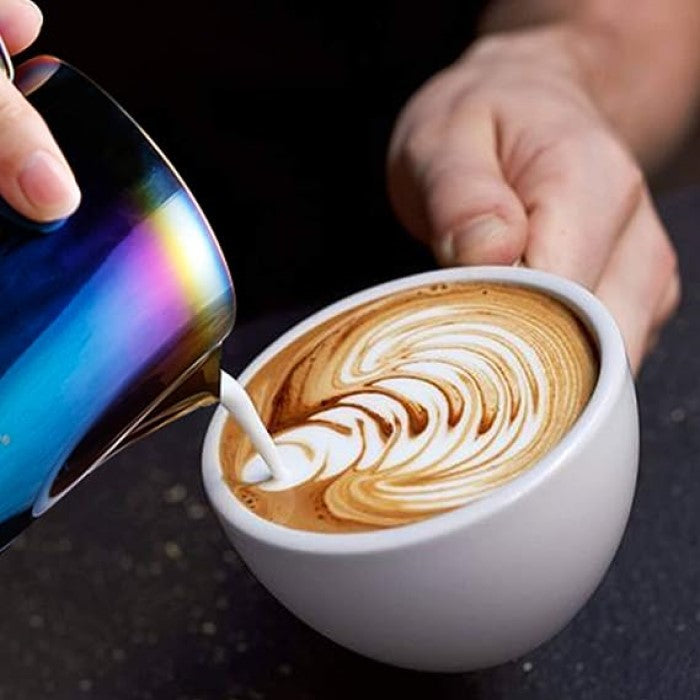 Iridescent Frothing Pitcher Pouring Into A Cappuccino 