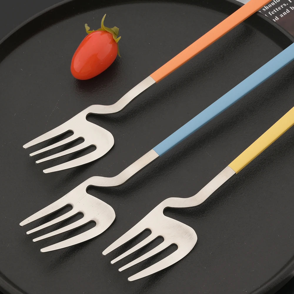 Unique Shape Forks Surreal Silverware With Colorful Handles In Orange Blue And Yellow