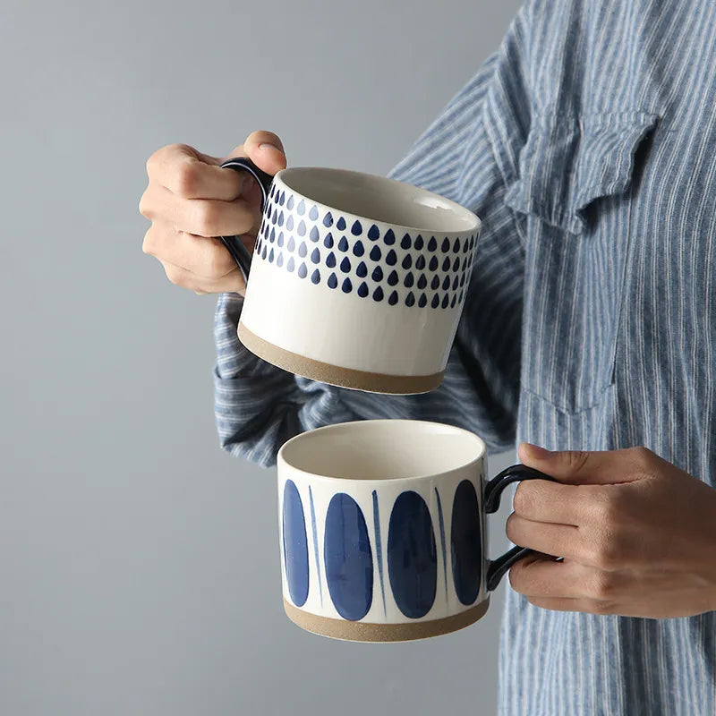 Holding Ceramic Mugs With Blue Pattern And Exposed Pottery Base Grounded Art Rains And Pools