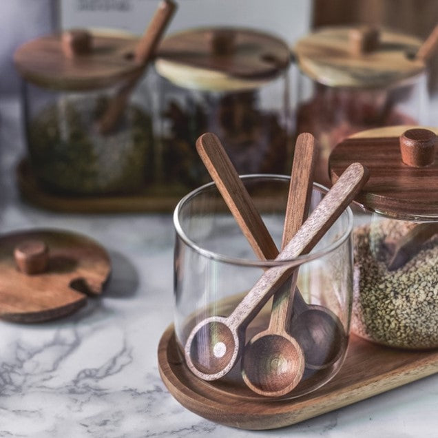 Round Wooden Acacia Spoons In Glass Spice Jar On Wooden Tray