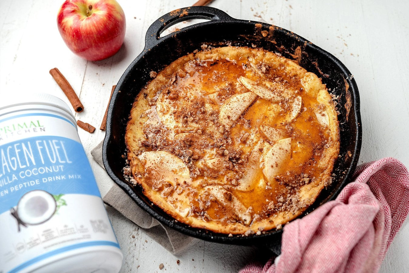Cast Iron Skillet Of Apple Cinnamon Primal Pancakes With Red Delicious Apple And Cinnamon Sticks Made With Vanilla Coconut Collagen Peptide Powder Recipe Primal Kitchen