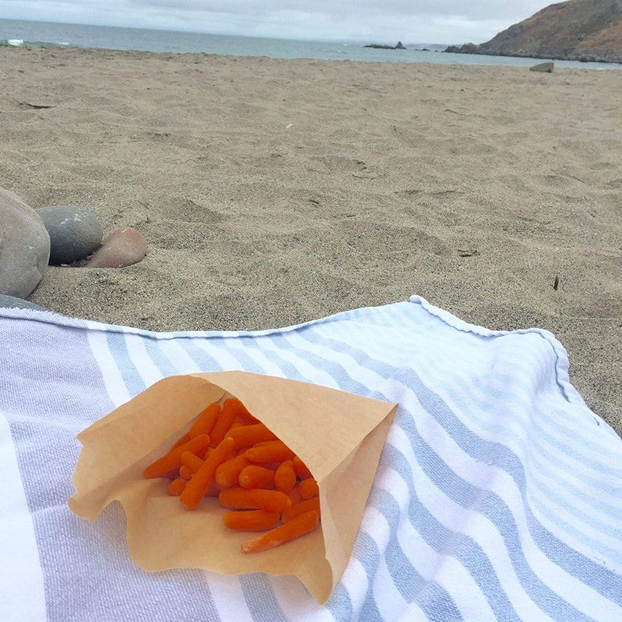 At The Beach Healthy Snack Of Baby Carrots In If You Care Paper Snack Bag