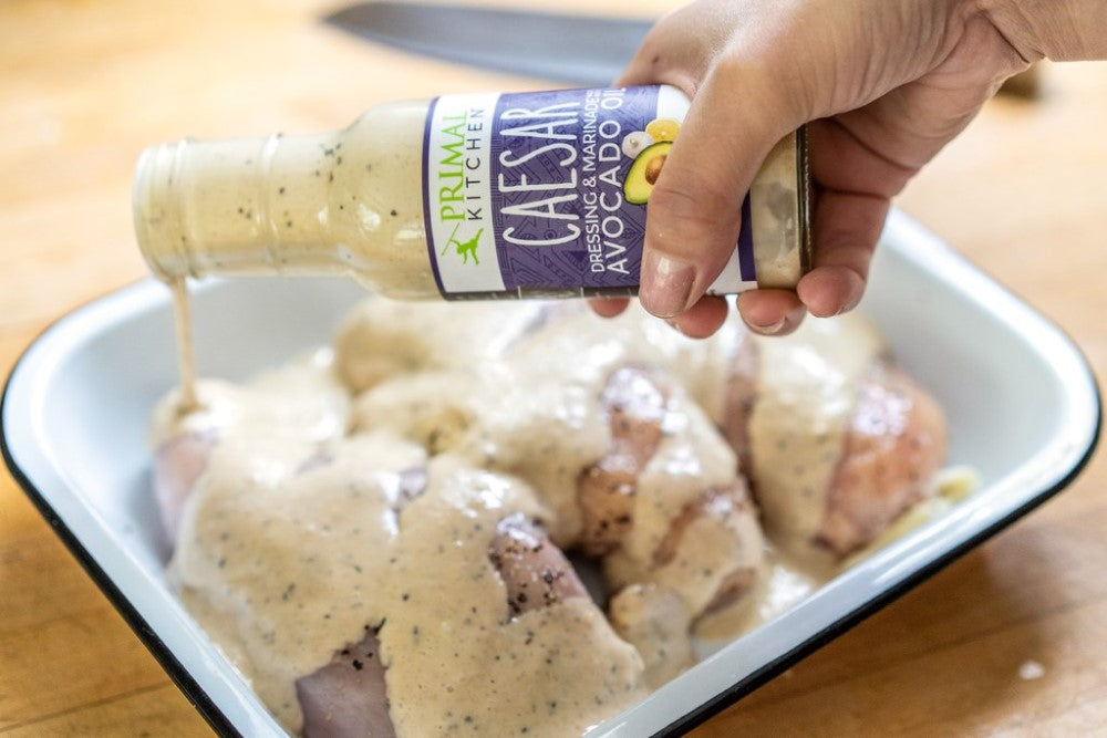 Pouring Creamy No Dairy Caesar Dressing On Chicken Primal Kitchen Recipe Baked Caesar Chicken Breasts