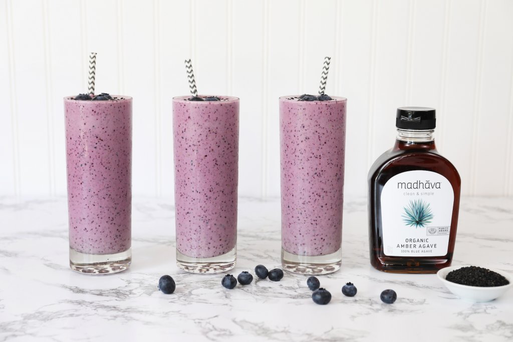 Black Sesame Blueberry Agave Smoothies On Marble Countertop With Fresh Blueberries Amber Agave Syrup And Black Sesame Seeds