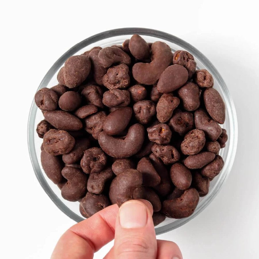 Reaching For Bowl Full Of Organic Chocolate Covered Hu Hunks