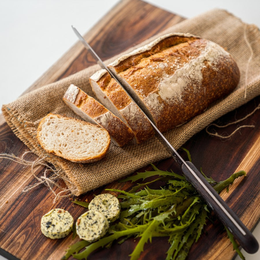 Organic French Bread Loaf Sliced With Herb Butter And Seaweed