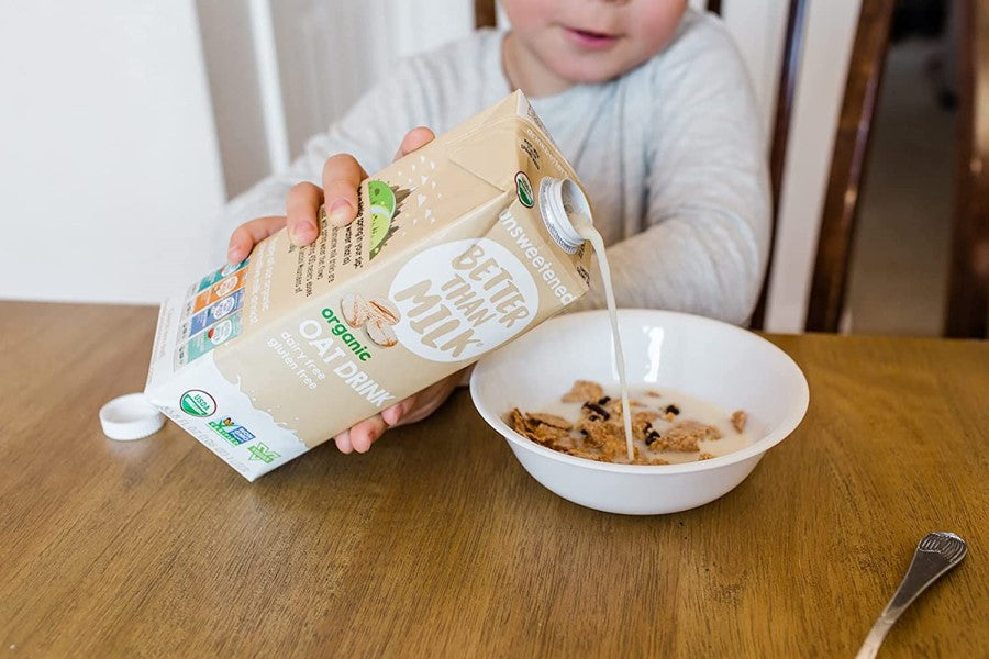 Child Pouring Dairy Free Gluten Free Oat Milk Drink In Bowl Of Cereal Unsweetened Better Than Milk Organic Brand