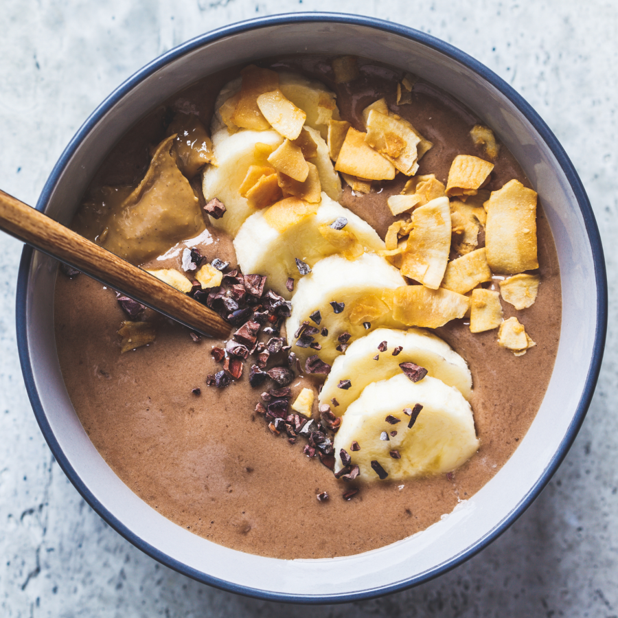 Chocolate smoothie bowl with Sacha Inchi powder from Imlakesh and topped with banana.