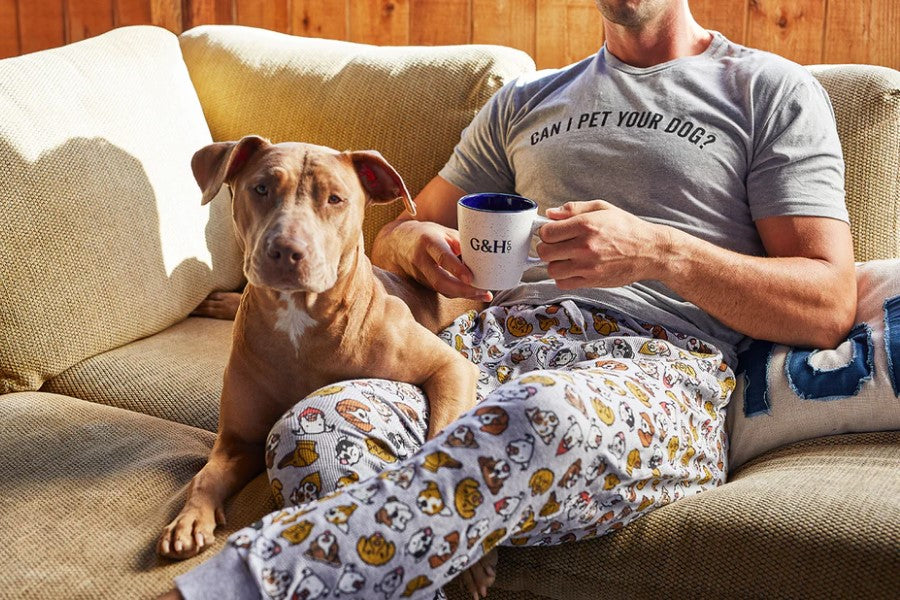Dog Sitting On Sofa With Man Drinking Coffee Holding G&H Co Mug Of Coffee Wearing Can I Pet Your Dog Shirt And Puppy Face Pajama Pants