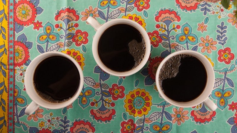 3 Cups Of Coffee On Colorful Tablecloth Equal Exchange Host A Coffee Tasting