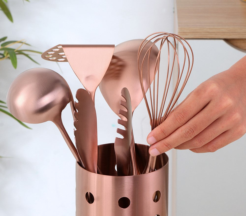 Chef Grabbing Stainless Steel Rose Gold Color Whisk From Set Of Kitchen Tools