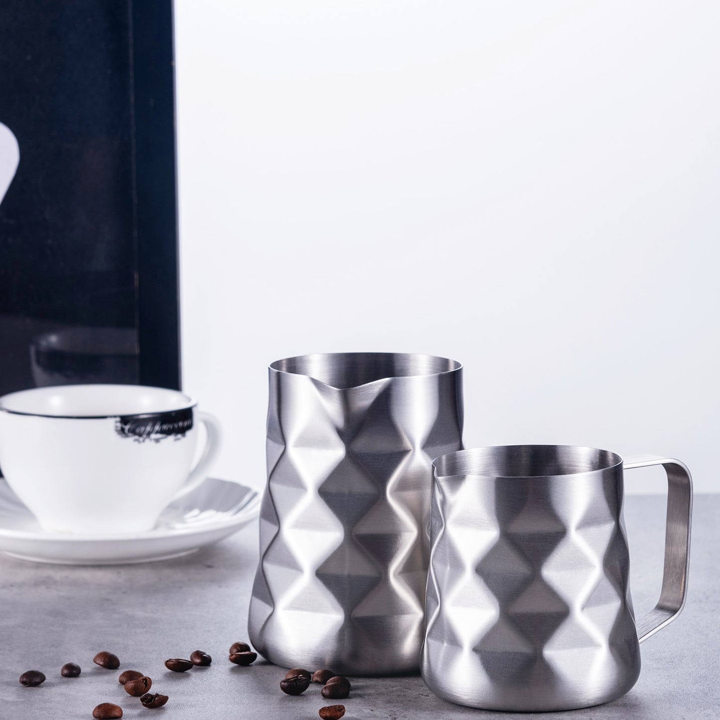 Modern Looking Kitchen Coffee Brew Gear Stainless Steel Prismatic Frothing Pitchers In 12 Ounce And 20 Ounce Sizes With Coffee Beans