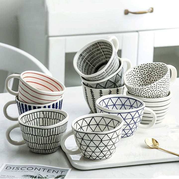Artistic Style Patterned Purposefully Irregular Shaped Ceramic Mugs On Kitchen Table