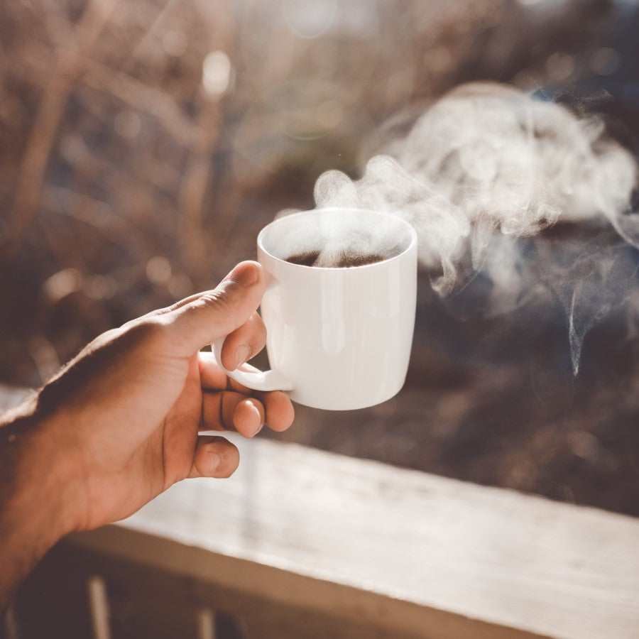 Hand Holding Steaming Hot Cup Of Organic Coffee Outdoors Brewed With Basket Style Unbleached Coffee Filters From Terra Powders