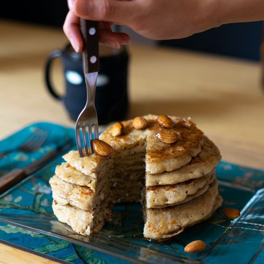 Person Eating Stack Of Healthy Pancakes Topped With Whole Organic Almonds From Terra Powders Market