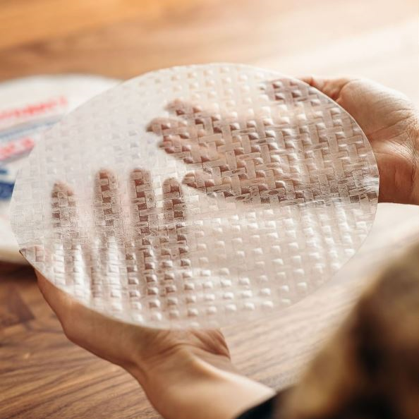 Hands Holding Translucent Rice Paper Sheet Dynasty Non-GMO Gluten Free Rice Wrappers