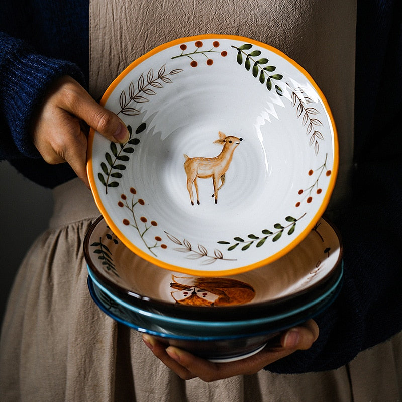 Holding Colorful Hand Painted Ceramic Bowls With Woodland Bavarian Forest Animals On Each Dish