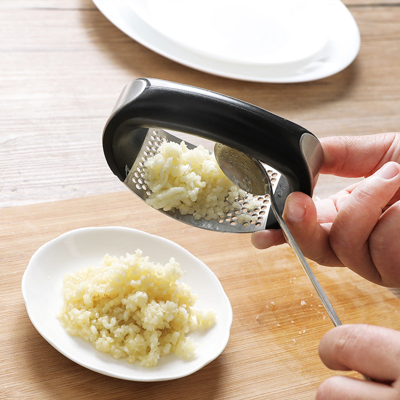 Using Stainless Steel Curved Style Garlic Rocker Press For Fresh Minced Garlic