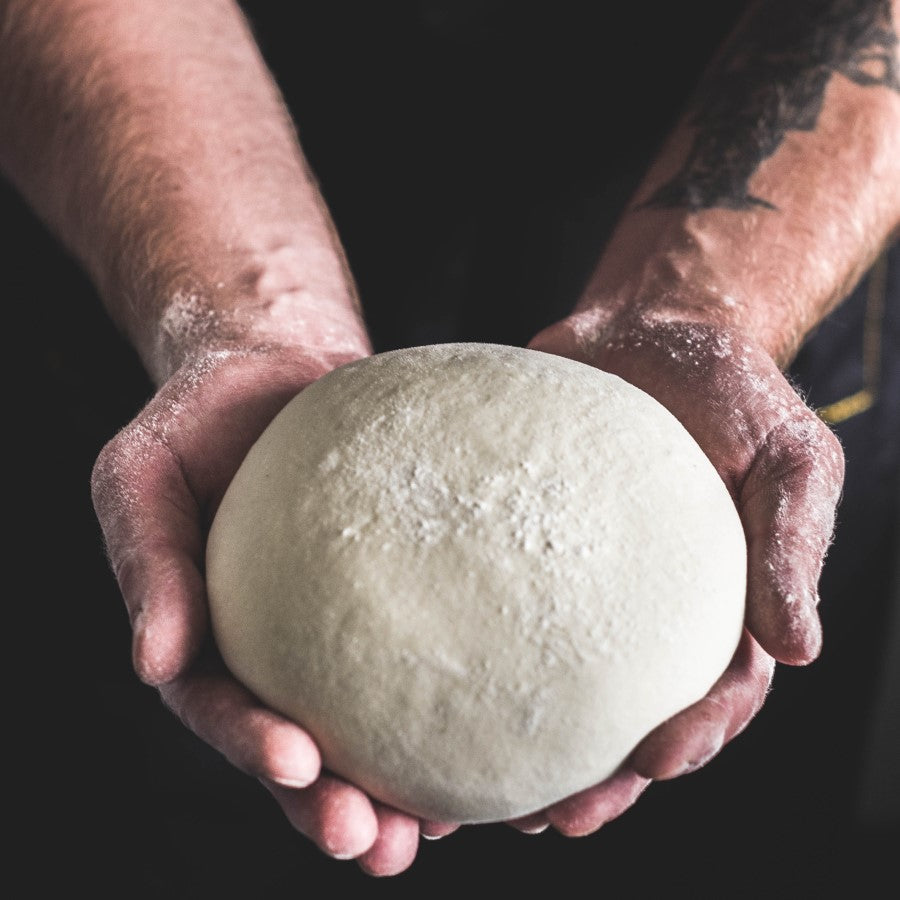 Bakers Hands Holding Dough Ball