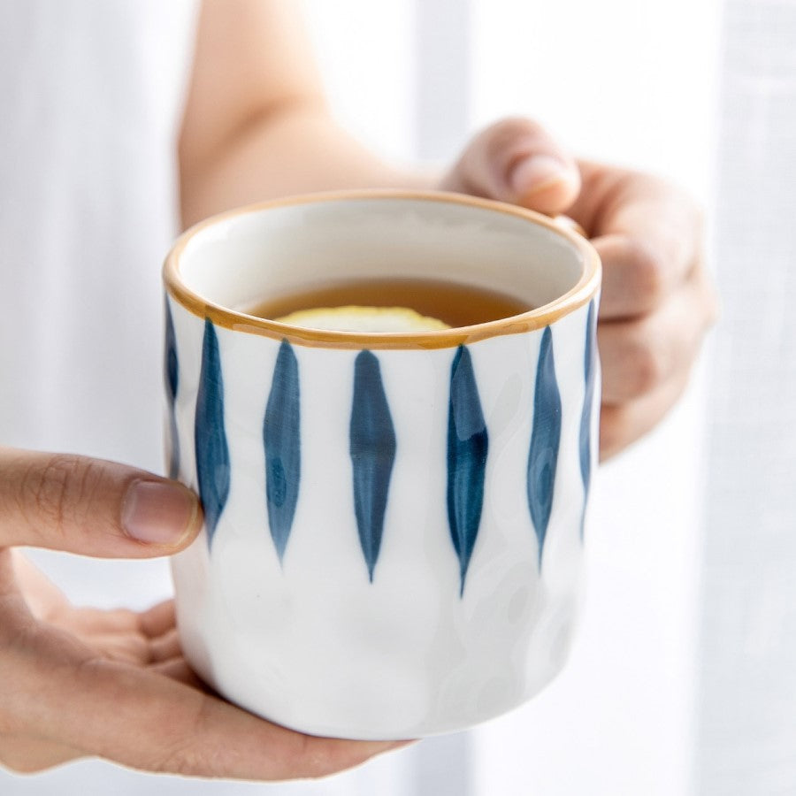 Holding A Ceramic Cup Of Herbal Tea With Lemon In Nautical Style Blue And White Pier Pattern