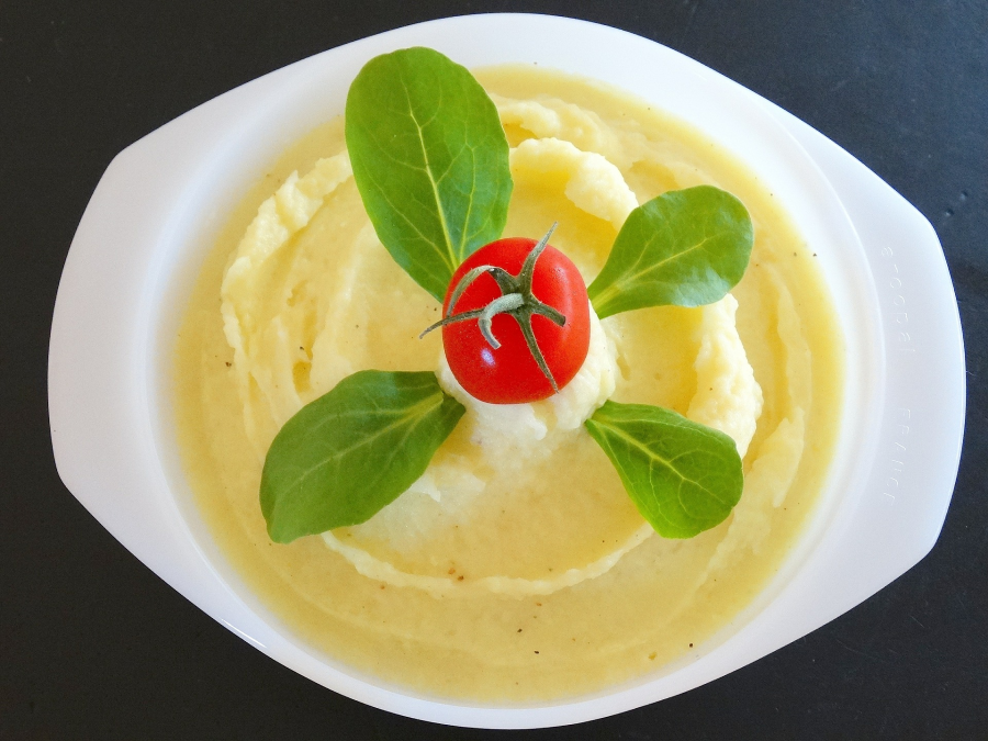 Interesting Looking Dish Of Leafy Green And Fresh Tomato Topped Mashed Potato Like Side Dish Made With Palmini Palm Hearts From Terra Powders