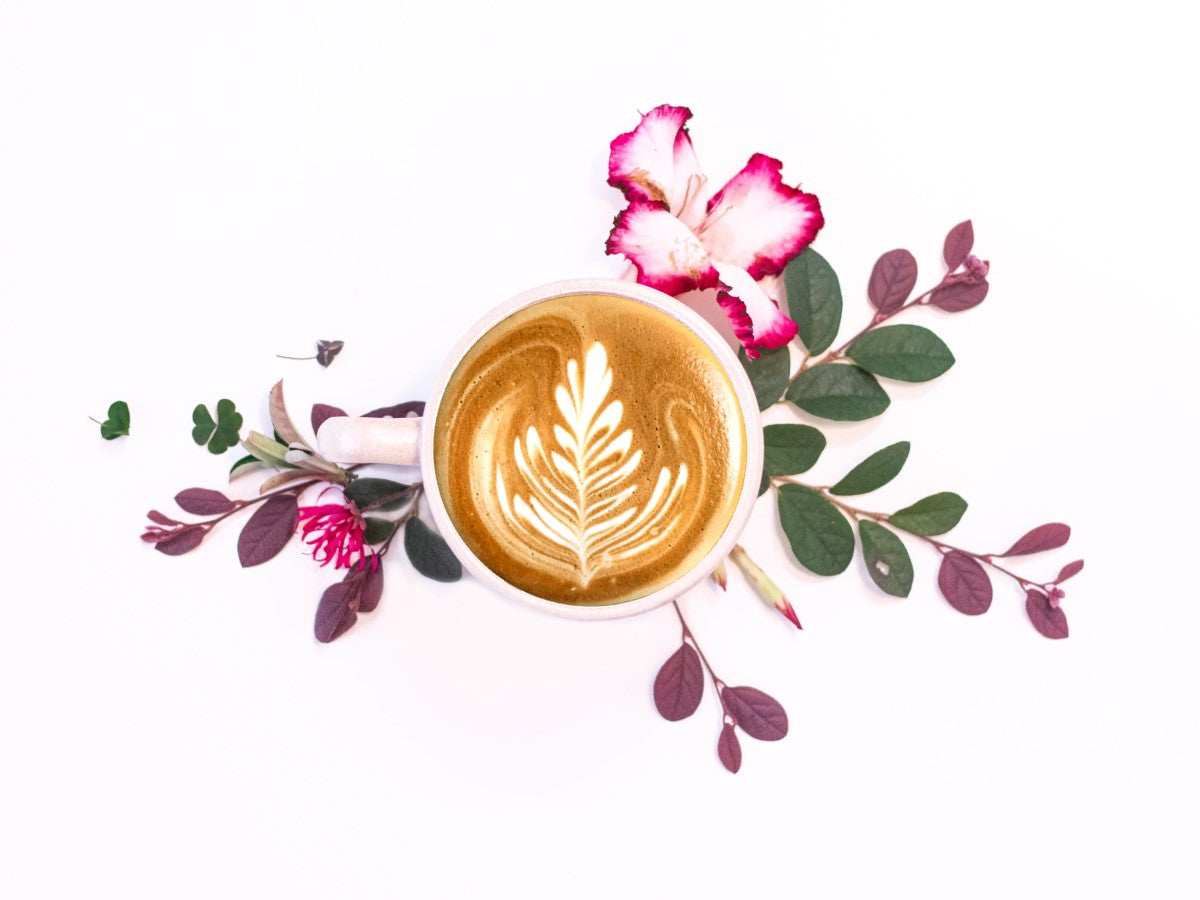 Foamy Coffee Latte With Pink Floral Composition