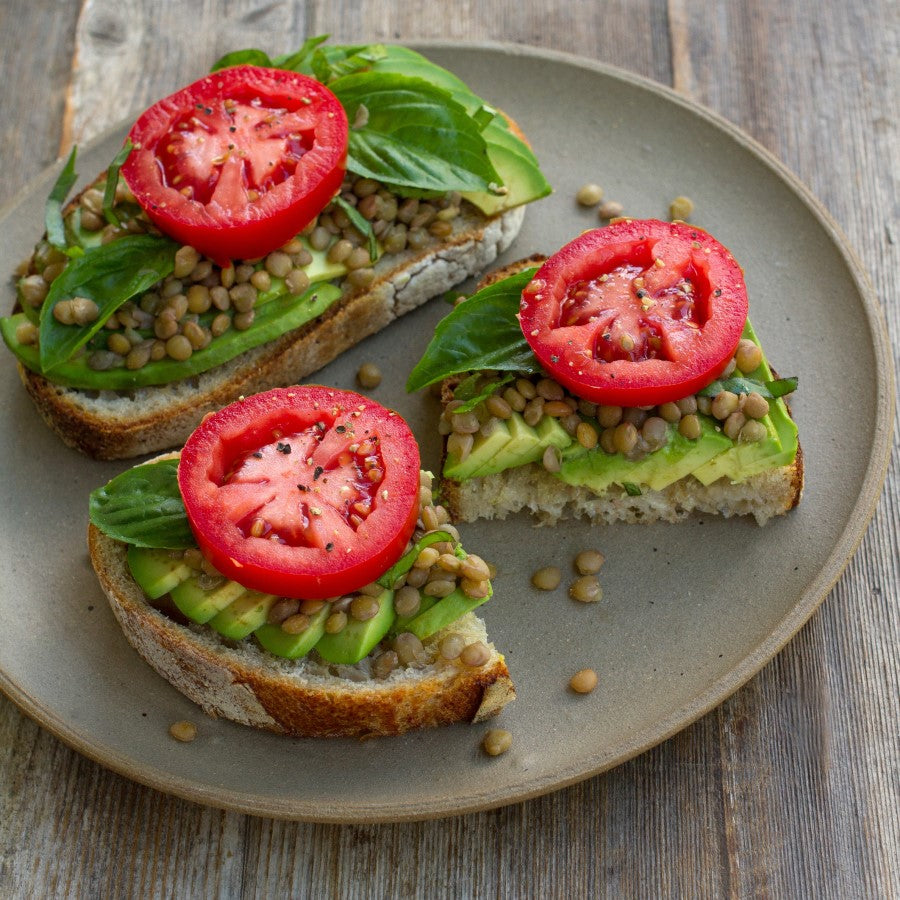 Lentil Avocado Herb And Tomato Topped Sourdough Bread Slices