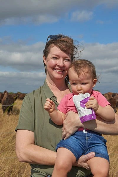 Mother Holding Baby Enjoying Grass Fed Bison Baby Food Serenity Kids Pouch