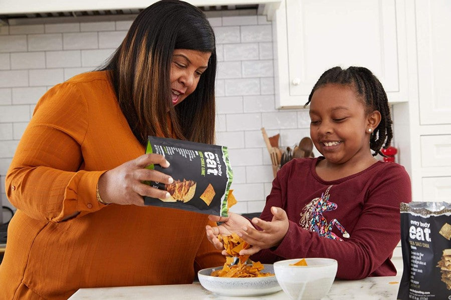 Mother Pouring Some Every Body Eat Fiery Chile Lime Cracker Thins For Daughter To Snack