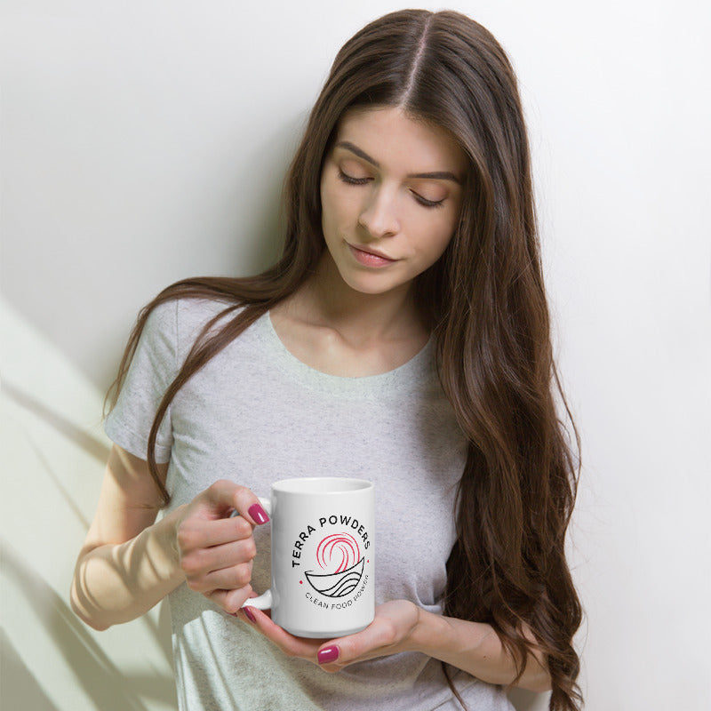Woman Holding 15oz Mug With Dragon Berry Pink Terra Powders Logo