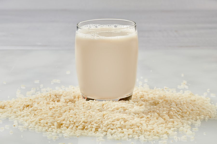 Organic Rice And Glass Of Better Than Milk Unsweetened Rice Drink With Calcium