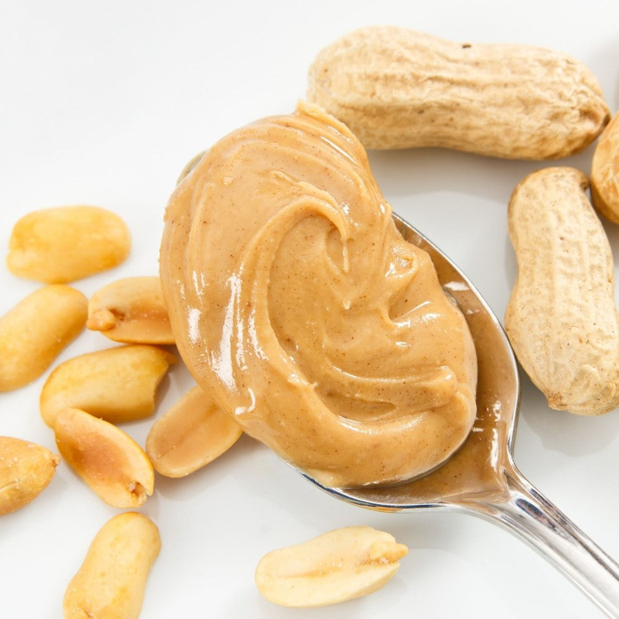 Peanut Butter with peanuts and shells in picture for Woodstock Organic Peanut Butter