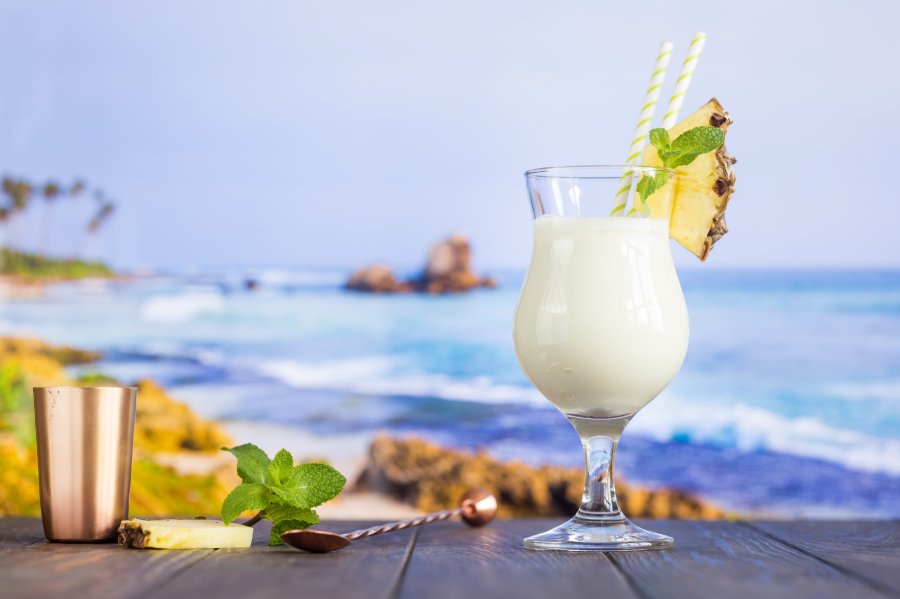 Coconut Water Tropical Pineapple Pina Colada Coconut Drink With Bar Tools And Blue Water Beach Background