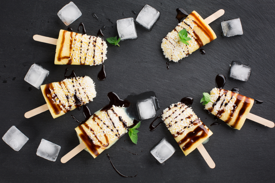 Ice Cubes And Pineapple Popsicles Made With Pineapple Coconut Water Topped With Shredded Coconut Healthy Chocolate Drizzle Garnished With Mint Leaves