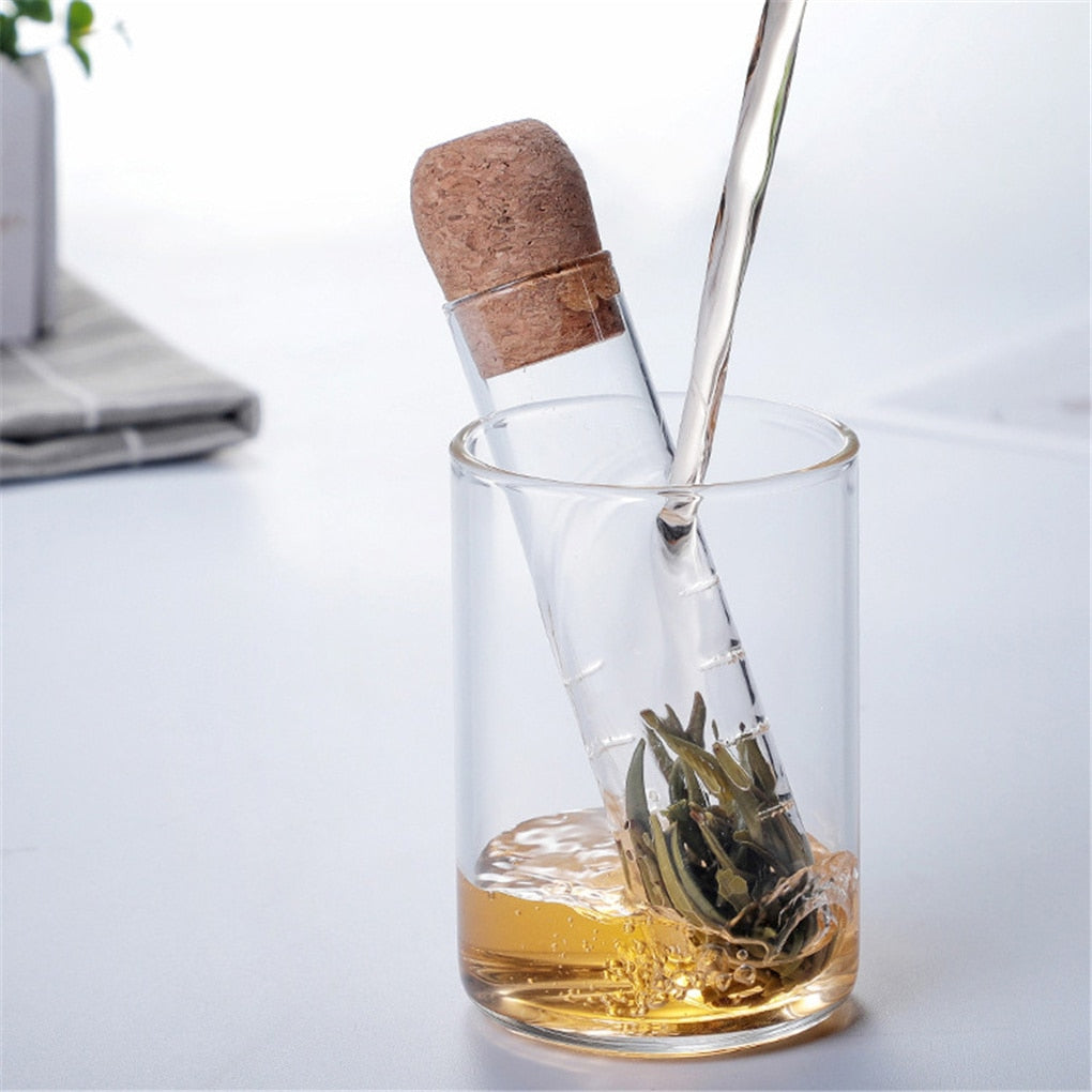 Pouring Water Over Glass Tube Shape Herb Infuser With Cork Top For Steeping Loose Leaf Herbal Tea